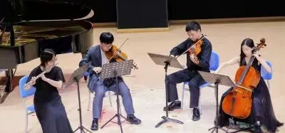Zimo performing with a chamber ensemble on stage
