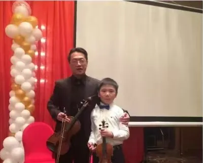 Young Zimo with a violin teacher