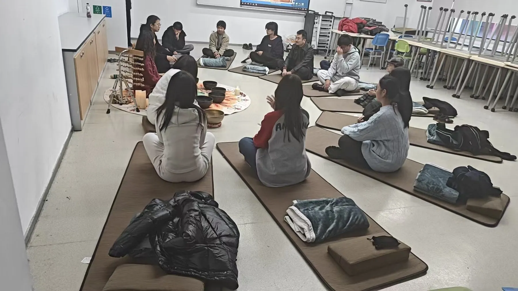 Students seated on mats during a breathing session